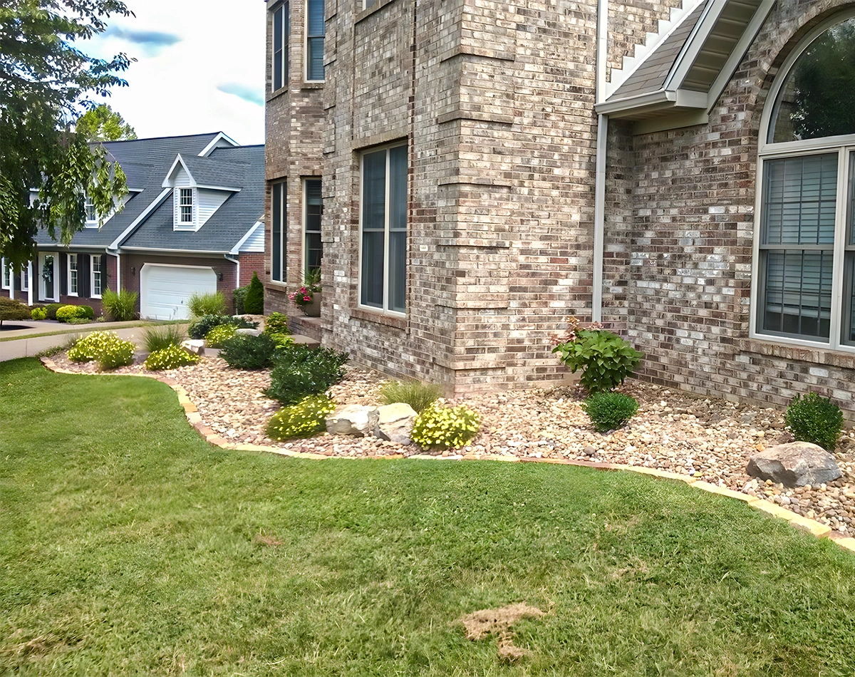 Residential landcare scene with maintained lawn, crisp beds, and an orderly home landscape